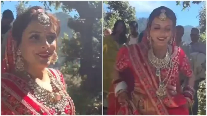Bride Sharmila walking to Undava village in Uttarakhand in her bridal lehenga