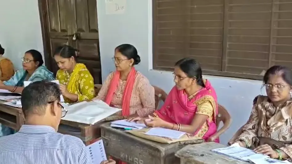 Officials checking voter list records during the SIR exercise in Basti.