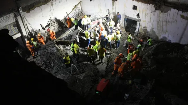 Rescue teams search rubble after a building slab collapsed in Harsh Vihar, Delhi.