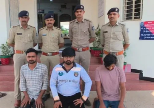 The three arrested accused (seated) with Tharad police personnel after their arrest.