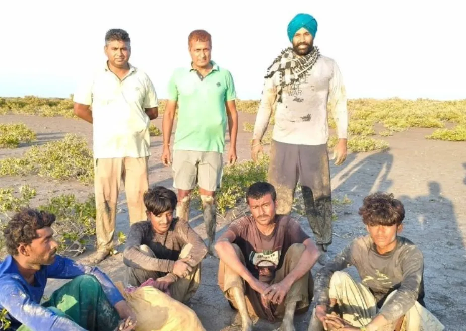BSF personnel with the apprehended fishermen in the Sir Creek area of Kutch.
