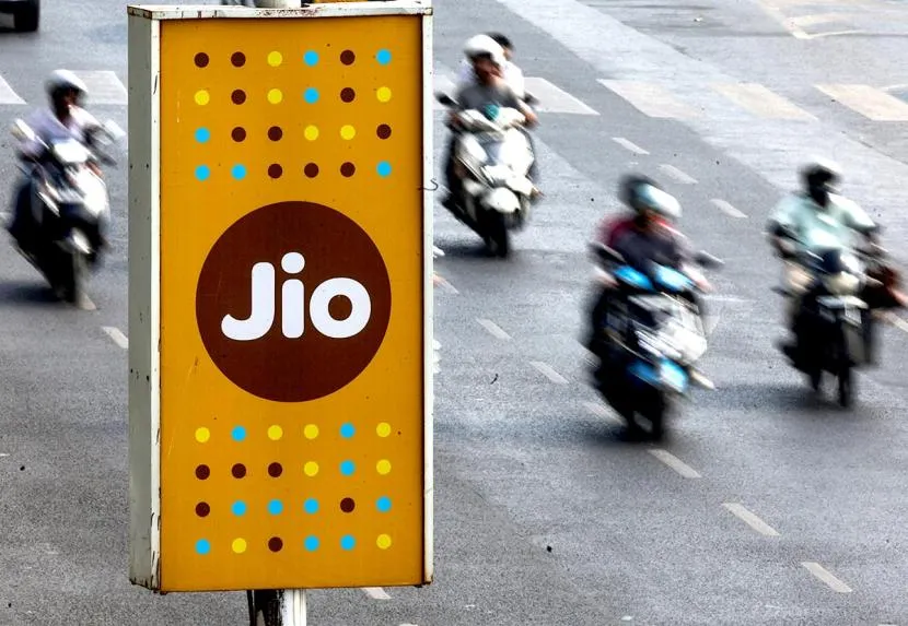 A Jio sign board on a busy road.